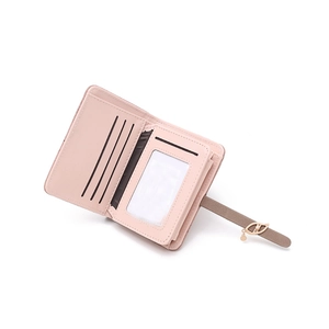 Detailed interior of a pink leather wallet featuring card slots and a clear ID window
