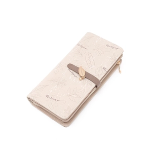 Detailed view of beige long wallet with leaf print and leaf-shaped metal pendant