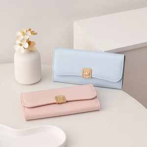 Detail of light blue and pink PU leather long wallets with elegant gold metal buckles