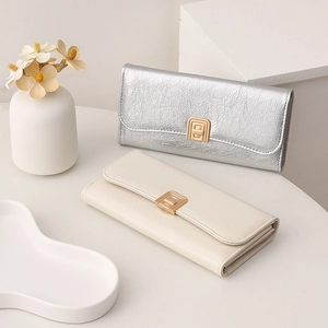 Detail of square women's wallets with wrinkled texture and gold buckles in two colors