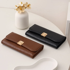 Detailed view of long leather wallets with golden square clasps in brown and black
