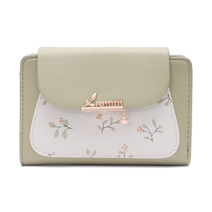 Close-up of sage green PU leather wallet featuring white floral pattern and leaf pendant