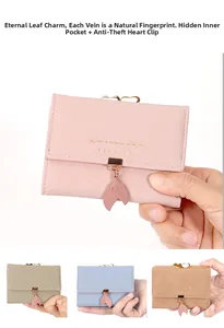 Detail of leaf pendant and golden heart clasp on the trifold short wallet for women