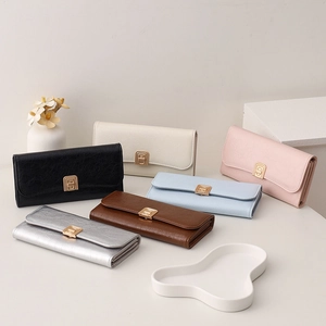 Flat lay of small crossbody phone bags in various colors with golden geometric buckles