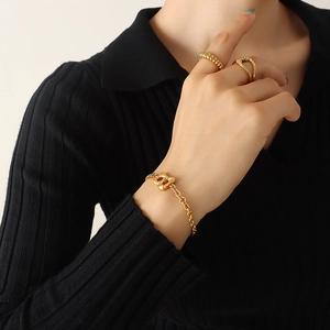 Golden B-letter charm bracelet with matching textured and criss-cross open rings