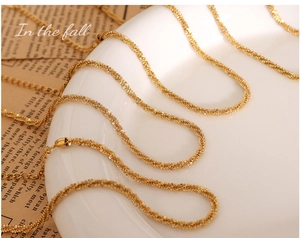 Detailed view of gold plated titanium steel anklet with braided texture on white porcelain