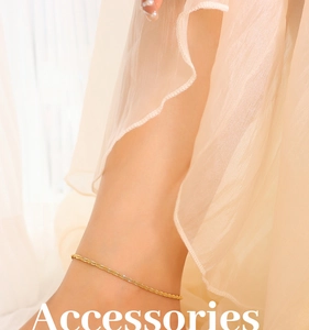 Detail of elegant gold double-layer thin chain anklet on a model's ankle