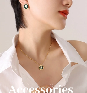 Detailed view of daisy floral green enamel jewelry set with gold necklace and earrings
