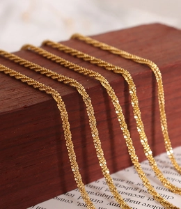 Close-up of 18K gold plated titanium steel anklet with intricate braided chain texture