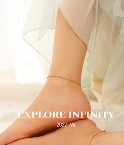Detailed close-up of 18K gold-plated titanium anklet worn with an elegant summer dress