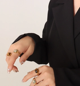 Retro gold chain rings with square tiger eye stones shown on model in black suit