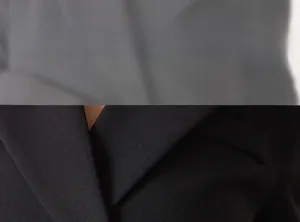 Detailed view of the tailored lapel and smooth seam stitching on the black suit jacket