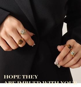 Detail of vintage gold chain rings with tiger eye and dalmatian jasper stones