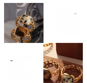 Close-up of vintage titanium steel ring with tiger eye stone and 18K gold chain band