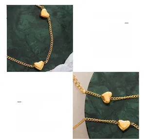 Macro detail of 18K gold plated titanium steel chain with solid heart pendants