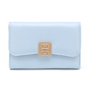Close-up of light blue leather wallet featuring a golden geometric twist lock closure