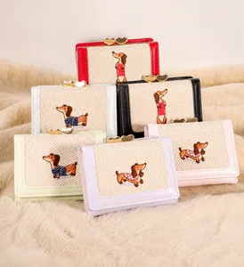 Detail of multi-color PU leather wallets featuring cute dachshund embroidery and heart clasp