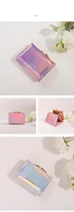 Detailed view of women's trifold wallet showing holographic material and metallic clasp