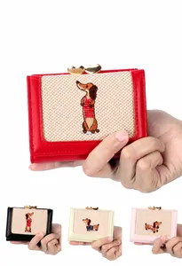 Detail of PU leather dachshund embroidery wallet with a gold heart-shaped metal clasp