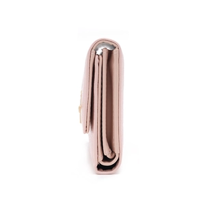 Side view of pink leather trifold wallet showing multi-layer structure and metal buckle