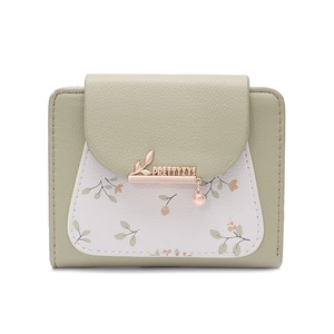 Detail view of the floral print pattern and metal leaf pendant on the women short wallet