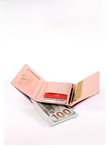 Detail view of pink tri-fold wallet showing card slots and large bill compartment