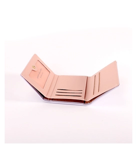 Detail view of pink trifold wallet interior with card slots and ID window