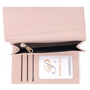 Detail view of pink trifold wallet interior with card slots, ID window and heart zipper