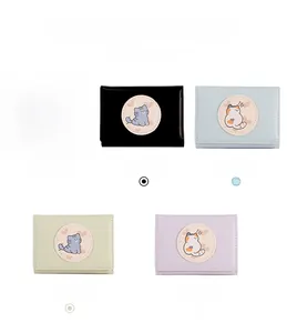 Close-up of trifold cat wallets in pink, black, blue, green and purple colors