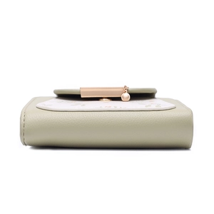 Detail view of the floral compact wallet base showing premium pebbled texture and gold hardware