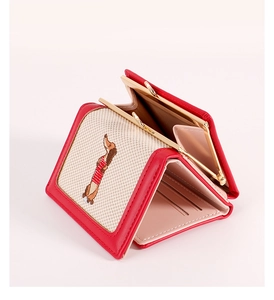 Detail of red PU leather tri-fold wallet featuring dachshund embroidery and gold clasp