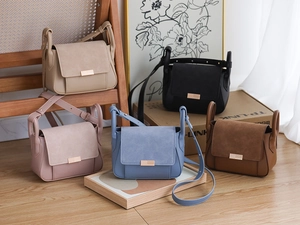 Detail showing high-quality stitching and metal buckle on multi-color crossbody bags