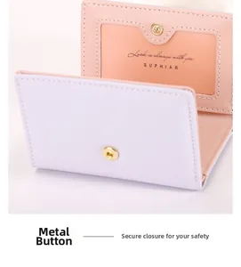 Detail view of the purple faux leather wallet featuring a golden snap button closure