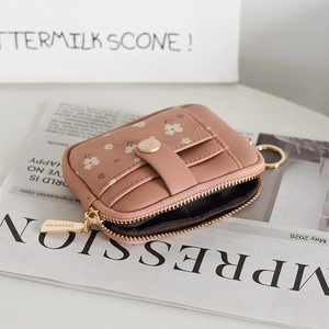 Detail of dusty pink floral mini wallet with gold zipper and built-in key ring