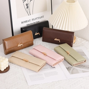 Detail of long leather wallets with gold leaf buckles in six elegant assorted colors