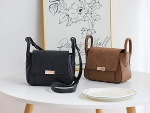 Detail of elegant crossbody bags in black and brown with textured suede panels