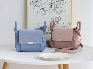 Minimalist crossbody bags in blue and pink featuring premium suede and leather patchwork detail