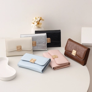 Short tri-fold wallets in six colors with gold metal buckles and crinkled faux leather