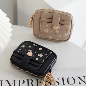 Floral print mini wallets in beige and black with gold zipper and card slots