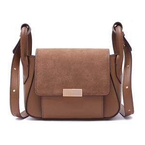 Detail of trendy crossbody bag showing suede and smooth leather texture with gold metal lock