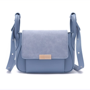 Close-up of Morandi blue crossbody bag with spliced leather texture and metal buckle