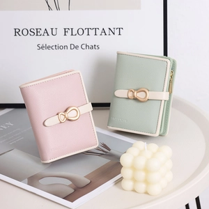 Close-up of minimalist women's short wallets with lychee texture and gold buckle detail