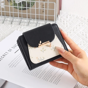 Short PU leather floral wallet for women featuring a leaf charm and brand logo detail