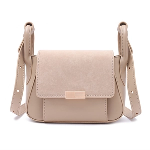 Detail of light khaki leather crossbody bag with suede patchwork and metal magnetic clasp