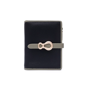 Detailed view of bicolor bifold wallet with Saffiano texture and metal bow buckle