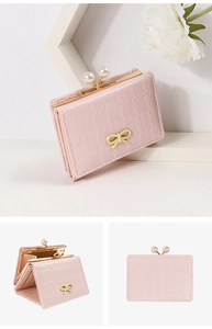 Close-up of pink PU leather wallet featuring pearl clasp and golden bow detail