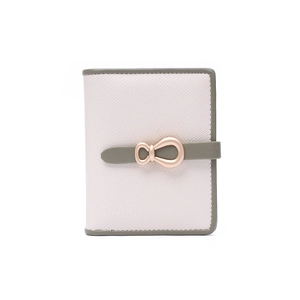 Close-up of pink minimalist wallet with green strap and gold bow metal buckle