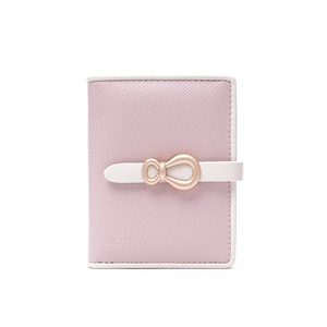 Detail of lavender pink faux leather wallet featuring a rose gold bow buckle closure