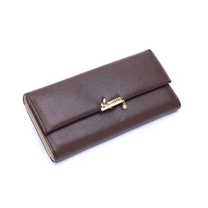 Detail of dark brown faux leather long wallet with gold leaf pendant and metal bar