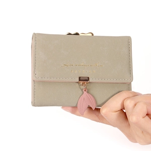 Handheld vintage khaki tri-fold short wallet for women featuring a pink leaf buckle charm
